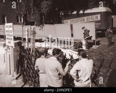 Vintage photo of Berlin Crisis of 1961: Building the Wall. East German Guards Put Up Large Panels To Hide Their Actions from Eyes and Cameras of West Stock Photo