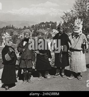 Art of Tibetan Masks. Vintage photo of Tibetan devil dancers, who guarantee to drive away the evil one. Darjeeling, India. 1907 Stock Photo