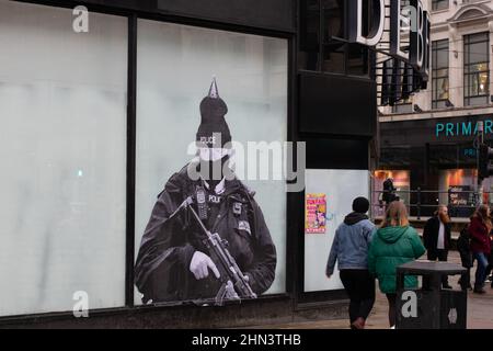 Boris Johnson dressed as a Metropolitan Police officer. Poster on window of former Debenhams department store, Market Street, Manchester. Stock Photo