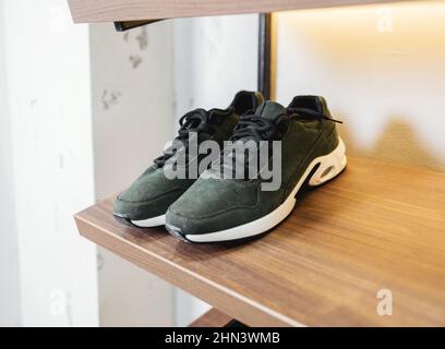 sports men's sneakers on the shelf stores. male shoes Stock Photo