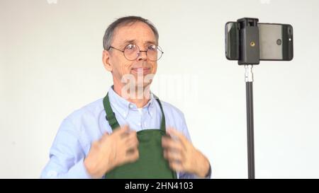 An elderly male blogger is broadcasting Stock Photo