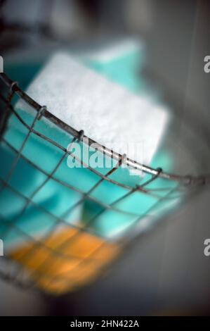 Washing-up sponges in wire basket Stock Photo
