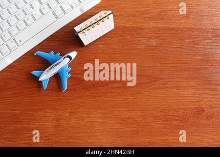 Travel, vacation concept. Top view image of keyboard, calendar and toy plane with copy space Stock Photo