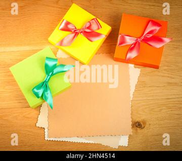 Three gift boxes with blank gift tag on wooden background Stock Photo