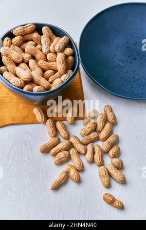 Image of bunch of peanuts in a bowl on a table Stock Photo