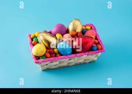 Colorful chocolate Easter eggs on blue background Stock Photo