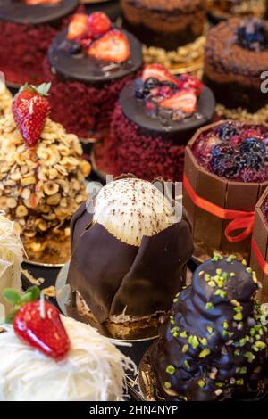 Small cakes on display at the patisserie counter Stock Photo