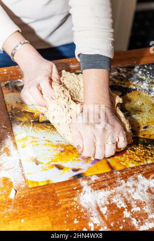 making bread,home baking, kneading dough,baking,bread making,home made bread,bread dough,kneading,dough,bread,home made,hard times,hand made,bread, Stock Photo