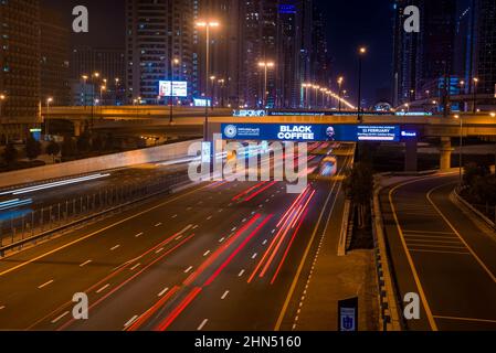 Long exposure of moving cars at night road in Dubai. Stock Photo