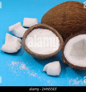 Summer tropical coconut on vibrant blue background. Minimal exotic fruits Stock Photo