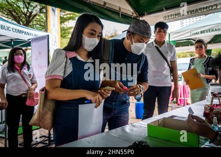 Bangkok, Thailand. 14th Feb, 2022. Couples provide identification and vaccine certificates at a mass marriage event on Valentine's Day in Bangkok.Couples gather to legally register their marriage during the 'Lover New Normal @ Bangrak' mass marriage event on Valentine's Day in Bangkok. Although it is common for people to legalize their marriage throughout the city's 50 district offices on this day every year, Bang Rak is amongst the most popular as its name resembles 'Place of Love' in the Thai Language. Credit: SOPA Images Limited/Alamy Live News Stock Photo