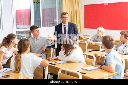 Teacher communicates freely with students in classroom at school Stock ...