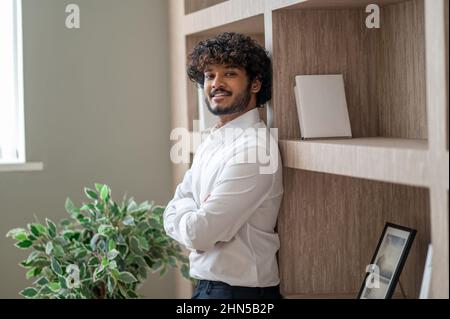 Young indian businessman sstanding with arms crossed Stock Photo - Alamy