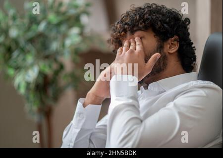 Dark-haired businessman feeling sleepy Stock Photo