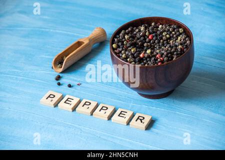 peppercorns on wooden bowl Stock Photo