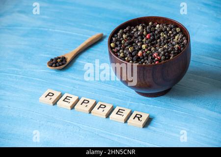peppercorns on wooden bowl Stock Photo