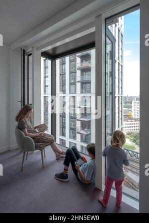 Children using the bay window. 8-13 Casson Square, London, United Kingdom. Architect: Patel Taylor Architects, 2022. Stock Photo
