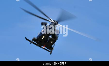 Thiene Italy, OCTOBER, 16, 2021 Modern military helicopter in flight in the foreground in the blue sky. Front close-up view. Agusta Westland AW139 HH1 Stock Photo