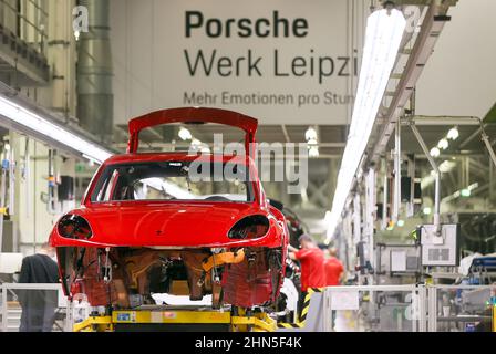 02 February 2022, Saxony, Leipzig: A Porsche Macan leaves the 'interior line' at the Porsche plant in Leipzig. The automaker will begin series production of the E version of its successful Macan model in Leipzig in 2023. In 2021, more than 88,000 Macans with internal combustion engines had been delivered to customers, it said. The conversion and expansion of the Leipzig plant is currently underway to prepare it for electromobility. Around 600 million euros are being invested, including in a new body shop and a dedicated axle production facility. Porsche is pursuing the goal of having all drive Stock Photo