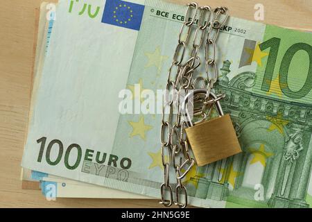 Closeup of euro banknote locked with chain and padlock - Stop cash concept Stock Photo