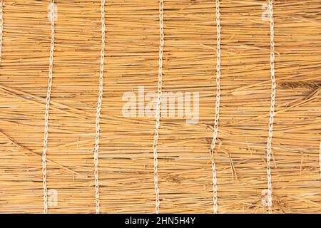 Wicker rug made from dry plants foliage of palm trees and bamboo Stock Photo