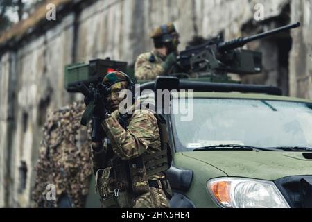 Cowardly rifle firing pose suppressing enemy . High quality photo Stock Photo