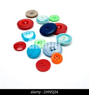 Assorted colorful buttons scattered on a white surface Stock Photo