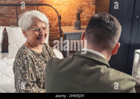 friendship between generations grandmother and middle-aged grandson grinning and laughing. High quality photo Stock Photo