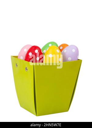 Multicolored easter eggs decorated dots in basket isolated on the white background Stock Photo