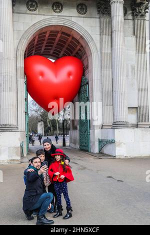 London UK 14 February 2022  A family  taking. a selfie in front of wellington arch which this valentines was showing his heart.Paul Quezada-Neiman/Alamy Live News Stock Photo