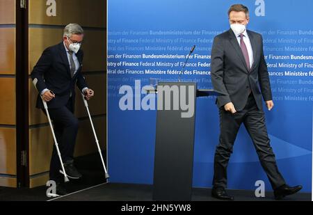 Berlin, Germany. 14th Feb, 2022. Christian Lindner (FDP), Federal Minister of Finance, receives his Austrian counterpart Magnus Brunner (l), who comes into the room with walking aids, at the Federal Ministry of Finance. Credit: Wolfgang Kumm/dpa/Alamy Live News Stock Photo