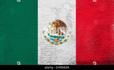 Full frame photo of a weathered flag of Mexico painted on a plastered brick wall. Stock Photo