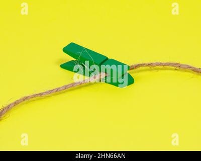 Clothes pins wooden on yellow background decorative Stock Photo