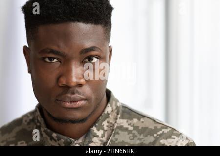 Closeup portrait of serious african american soldier looking at camera Stock Photo