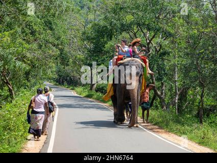 SIGIRIYA, SRI LANKA - MARCH 16, 2015: Tourists ride an elephant in the vicinity of Mount Sigiriya, Sri Lanka Stock Photo
