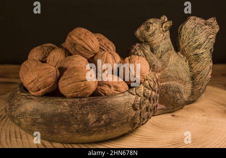 walnuts in bowl on a wooden table. rustic style bowl squirrel Stock Photo
