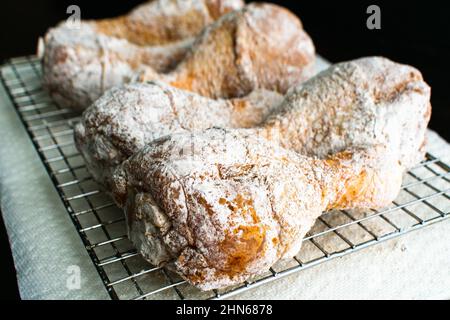 Raw Breaded Chicken Drumsticks on a Wire Rack: Breaded uncooked chicken legs being prepped for frying Stock Photo