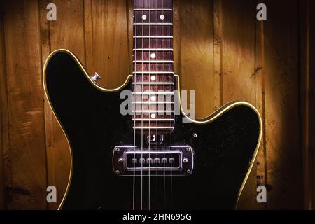 Details of an old electric guitar, used and dusty. Stock Photo