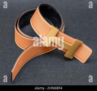 Hermes brass belt buckle and tan leather belt Stock Photo
