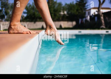 Reading a water thermometer in swimming pool, checking water temperature  Stock Photo - Alamy