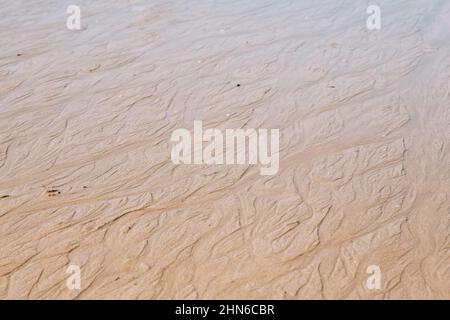 Sand texture background. Nature sand top view on beach in summer. Wave pattern on the coast. Close up of some sand on the shore Stock Photo