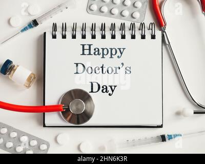 Happy Doctor's Day. Greeting Card. Close-up, view from above, nobody. Concept of preparation for a professional holidays. Congratulations for loved on Stock Photo