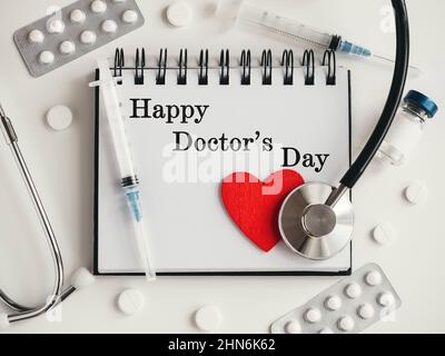 Happy Doctor's Day. Greeting Card. Close-up, view from above, nobody. Concept of preparation for a professional holidays. Congratulations for loved on Stock Photo