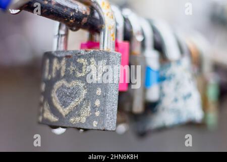 Love padlocks with drops of rain in close-up view. Stock Photo