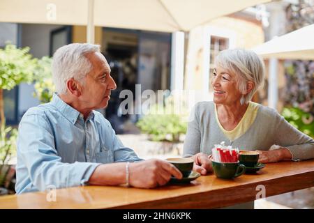 Having coffee after meeting at an online dating site. Shot of a senior couple having coffee at a cafe. Stock Photo