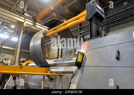 Sheet metal bending on an industrial roller machine. Industry. Stock Photo