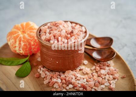 Himalayan pink salt in wooden bowl on wooden background Stock Photo