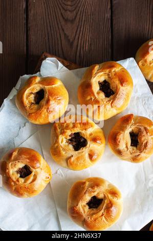Middle Asian authentic baked meat hand pies  - belyash or samsa served on baking paper, top view, copy space. Stock Photo