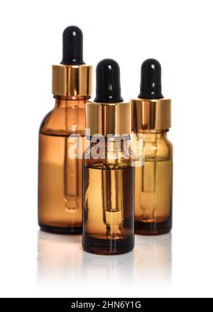 Three Dropper brown glass Bottles Mock-Up isolated on white background Stock Photo
