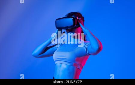 Female architector wearing virtual reality headset and making gestures with hands. VR technology for industrial design, development, architecting. Stock Photo